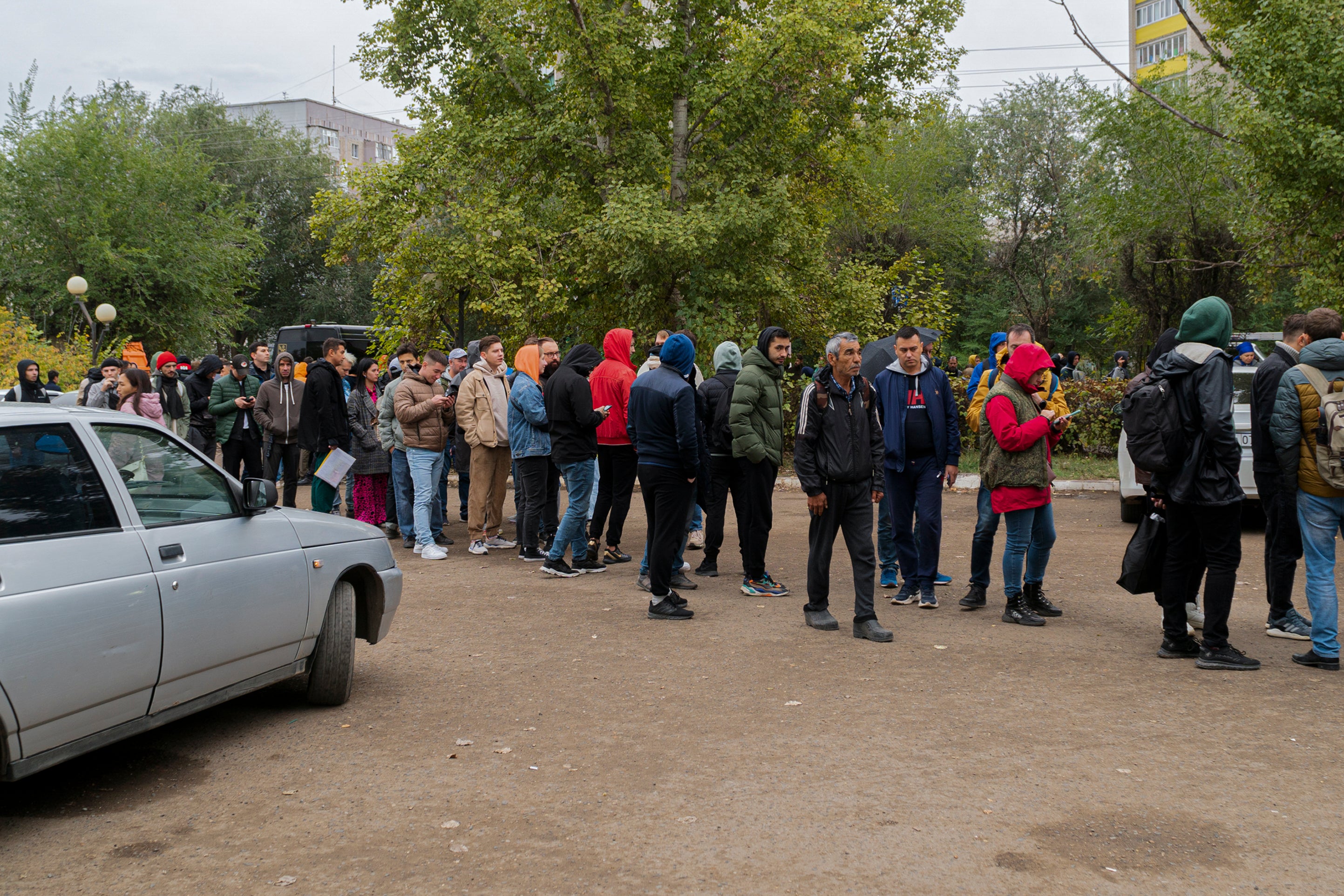 Russians line up to register after crossing the border into Kazakhstan about 250 miles south of Chelyabinsk on Wednesday