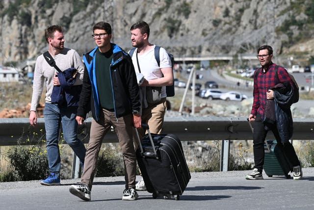 <p>Russians arrive in Georgia at the Kazbegi/Verkhniy Lars border crossing point on Wednesday</p>