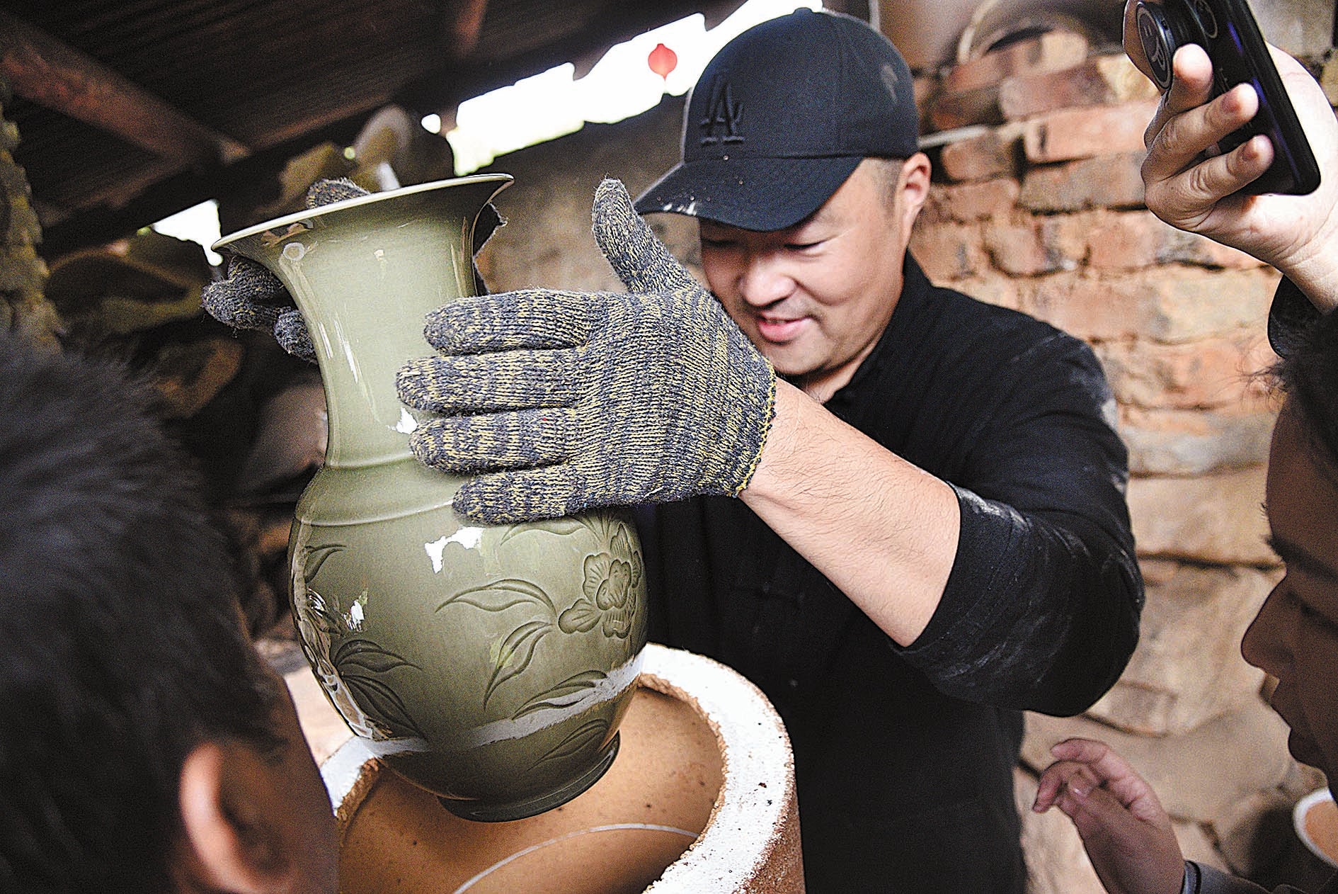 A celadon vase is removed from a kiln in Longquan, Zhejiang province, in 2018