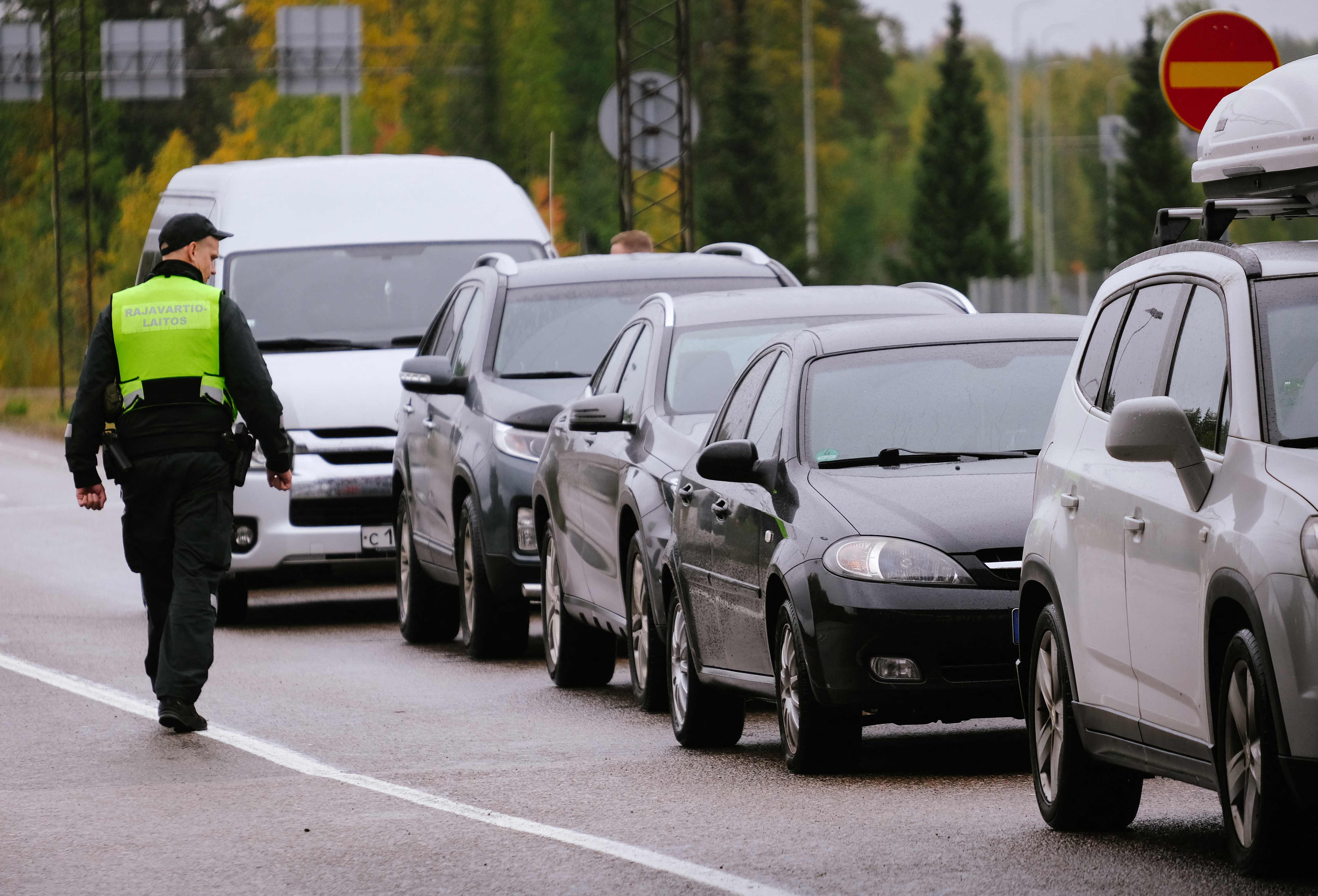 A border guard officer controls the vehicles entering Finland at the border checkpoint crossing in Vaalimaa, Finland, on the border with the Russian Federation