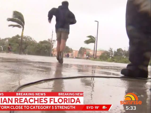 <p>A cameraman dropped his equipment to help people fleeing floodwater in southwest Florida </p>