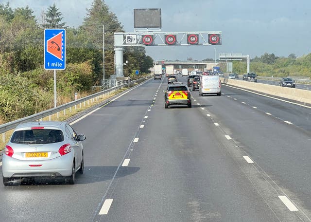 <p>All-lane running: a ‘smart’ section of the M4 motorway west from London, showing a sign for an emergency refuge and gantry with speed restrictions</p>