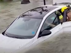Dramatic video shows moment a Florida woman is rescued from nearly submerged car during Hurricane Ian flooding