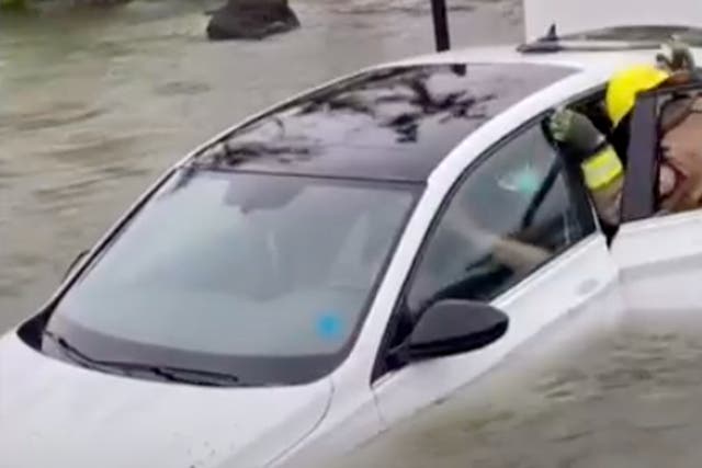 <p>A woman in Naples, Florida, is rescued by firefighters during Hurricane Ian after her car is rendered inoperable due to flooding </p>
