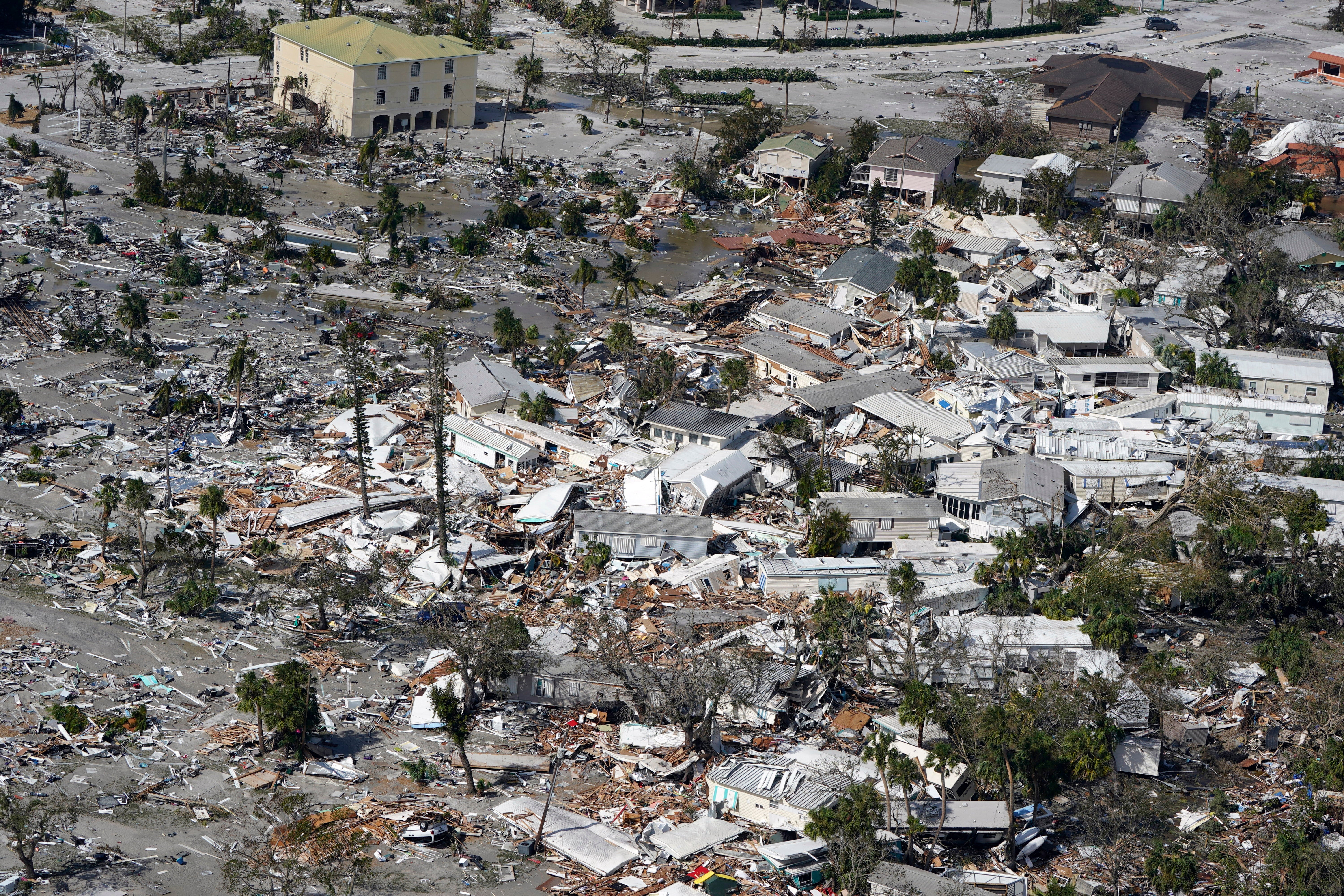 Damaged homes and debris are shown in the aftermath of the hurricane in Fort Myers
