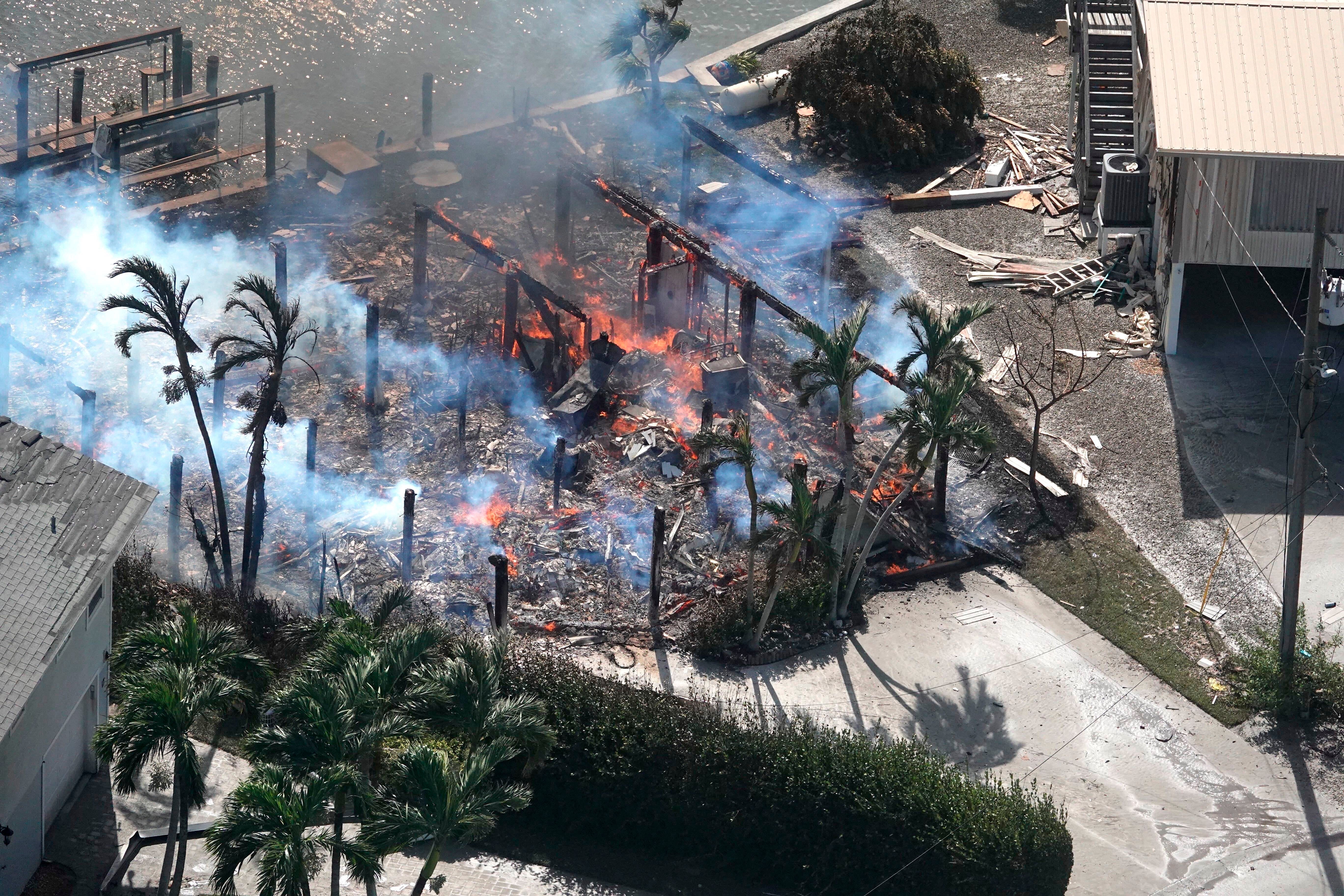 A building in Fort Myers smoulders after it caught fire during Hurricane Ian