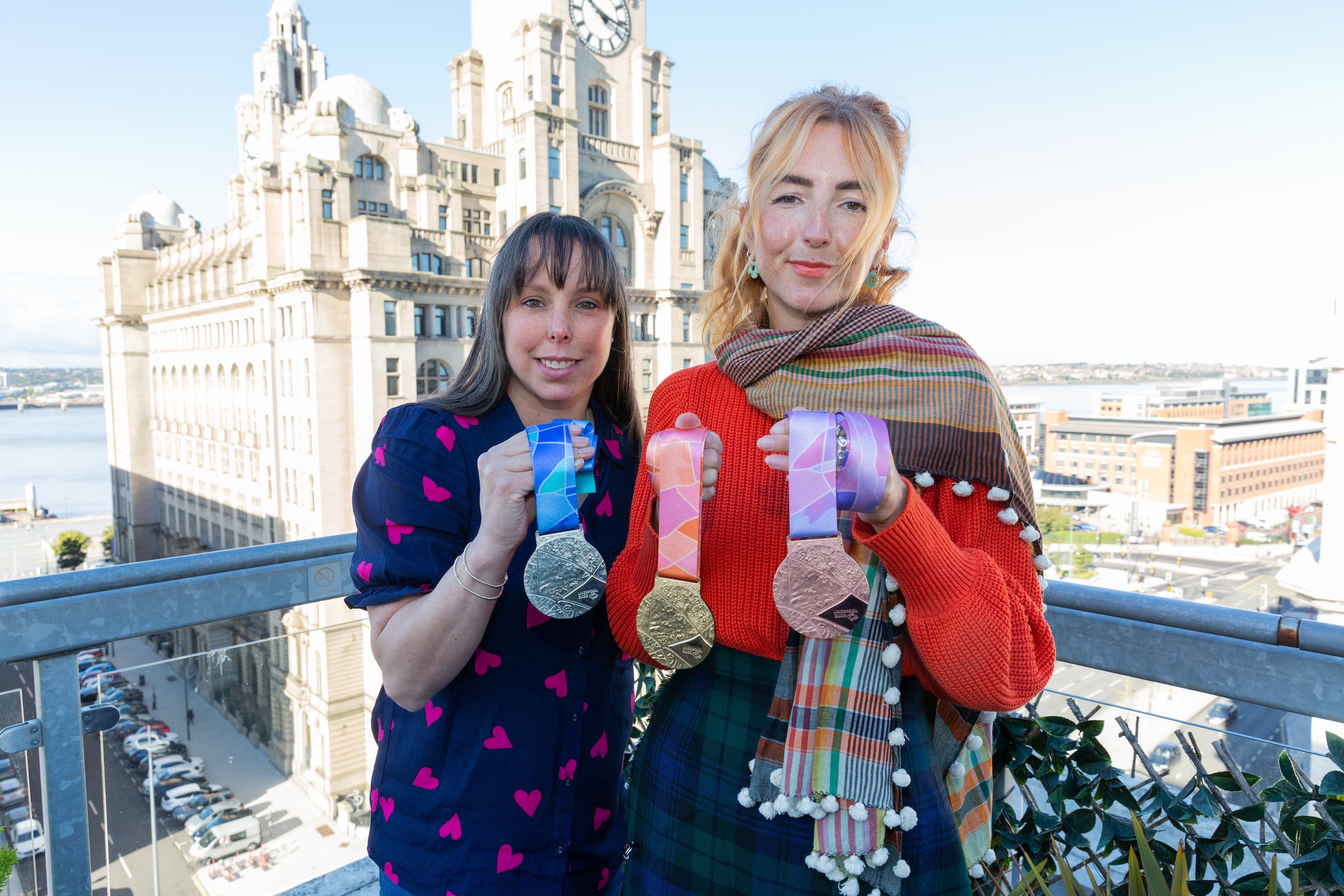 Three-time world champion Beth Tweddle, left, and designer Amy Flynn, right, with the new World Gymnastics Championships medals