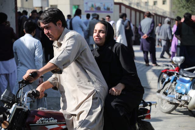 <p>A woman arrives on a motorbike to search for a relative at a hospital in Kabul on 30 September 2022 after a blast in a learning centre in the Dasht-e-Barchi  </p>