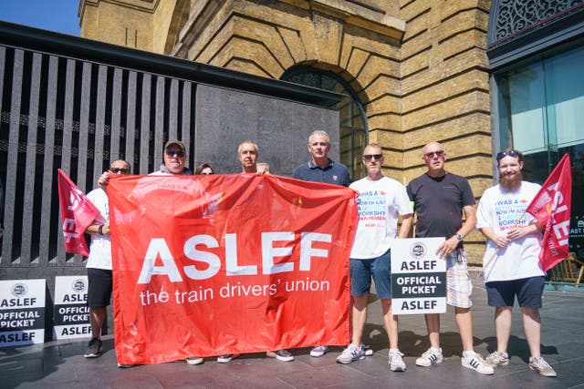 Picketing Aslef members at a picket line at Kings Cross station in London in August (Dominic Lipinski/PA)