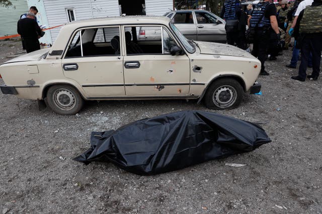 <p>A bodybag at the scene in Zaporizhzhia. At least 25 people have been killed</p>