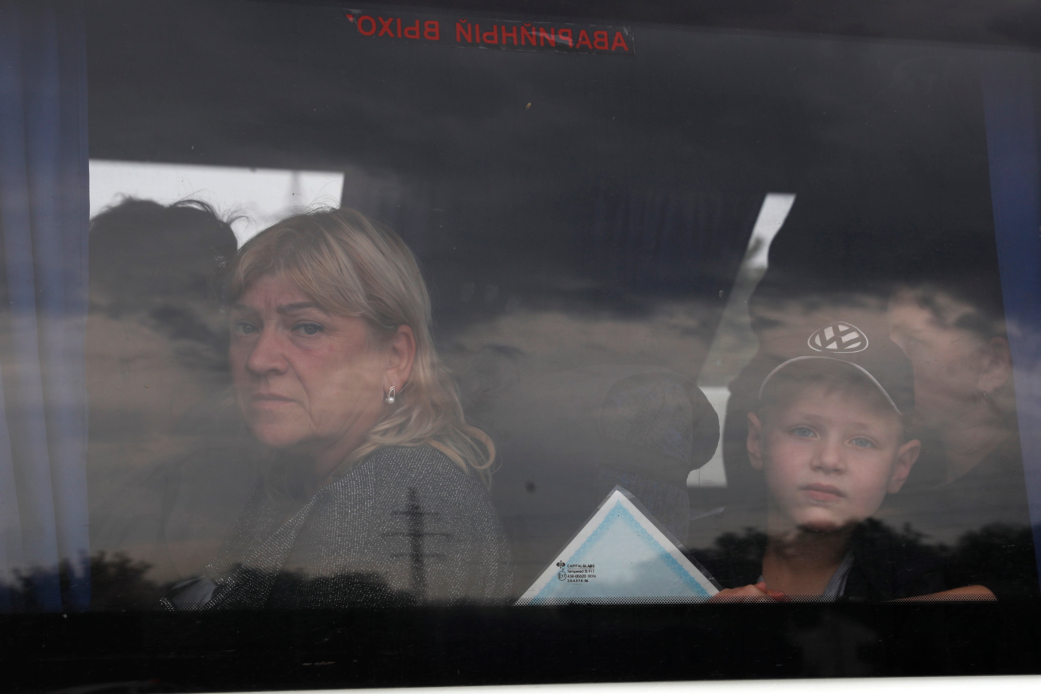 Ukrainians leave the occupied part of Zaporizhzhia with a Ukrainian police escort after a convoy of civilians was struck by a Russian missile