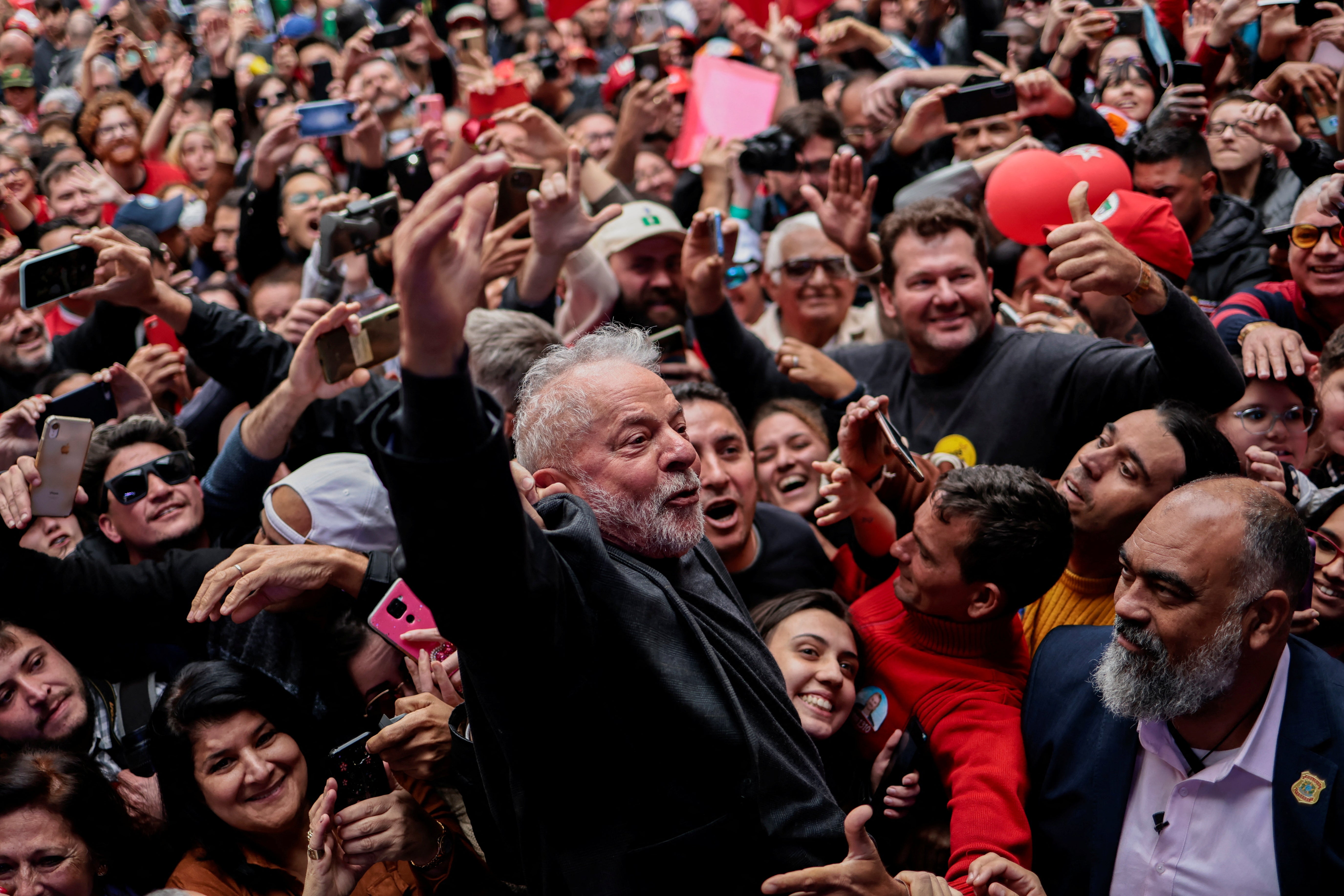 <p>Lula greets supporters during a rally in Curitiba</p>