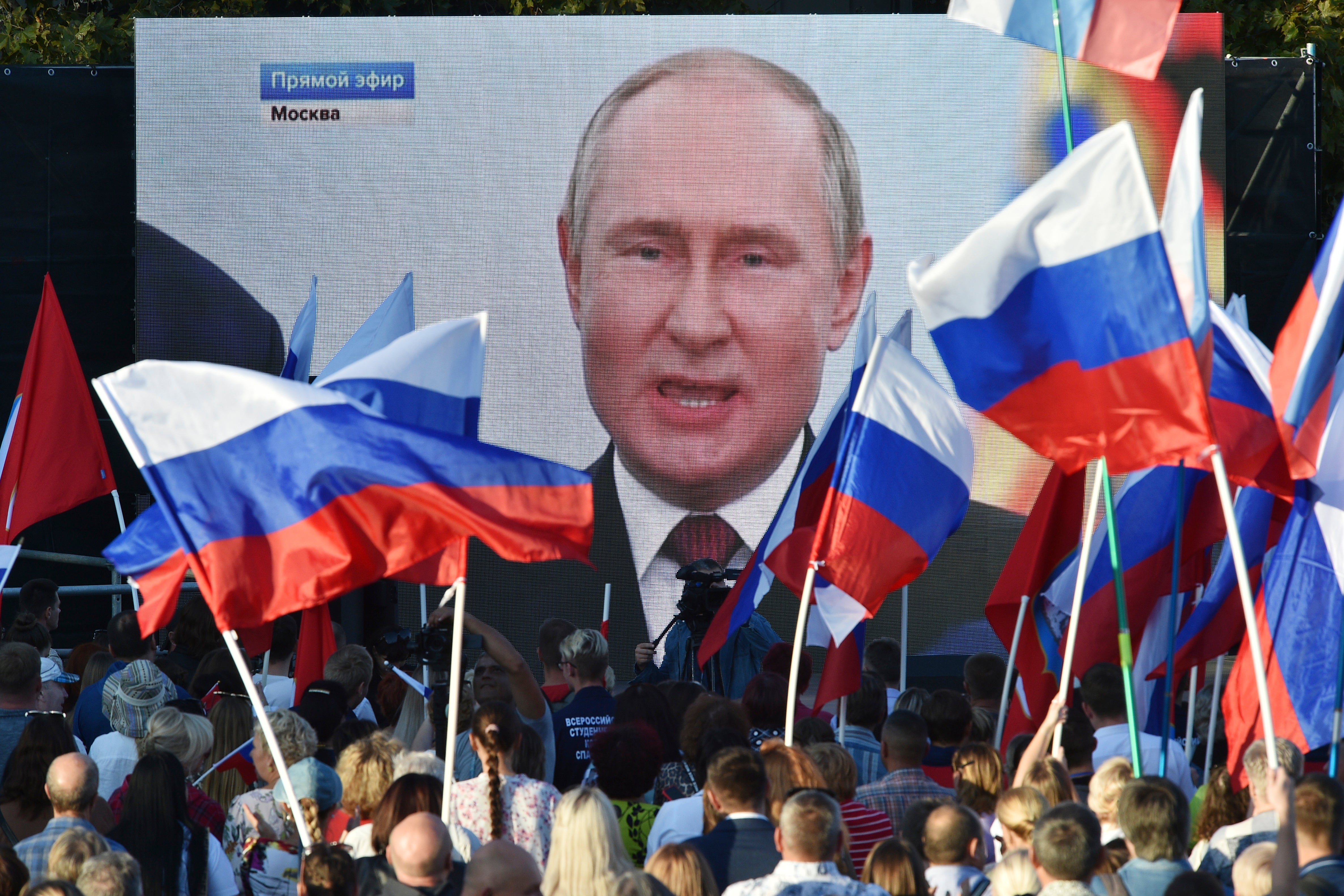 Crowds watch on a large screen as Vladimir Putin declares Russia is annexing four regions of Ukraine