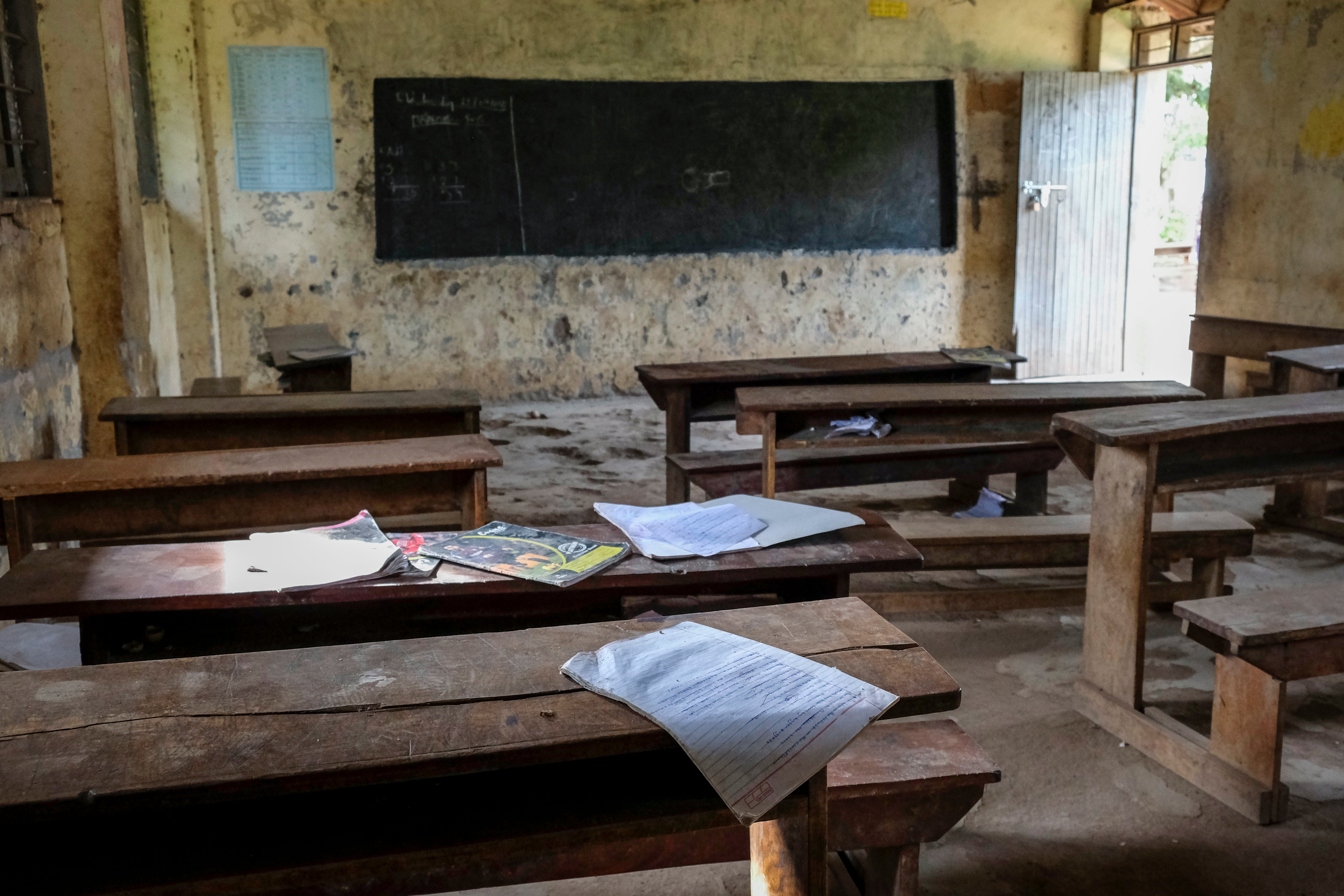 Pupils' books sit abandoned in a classroom at Madudu Catholic Church school, where many students have stayed away due to the risk of Ebola, in Madudu