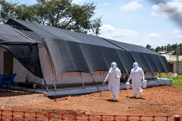 <p>Doctors walk inside the Ebola isolation section of Mubende Regional Referral Hospital, in Mubende, Uganda</p>