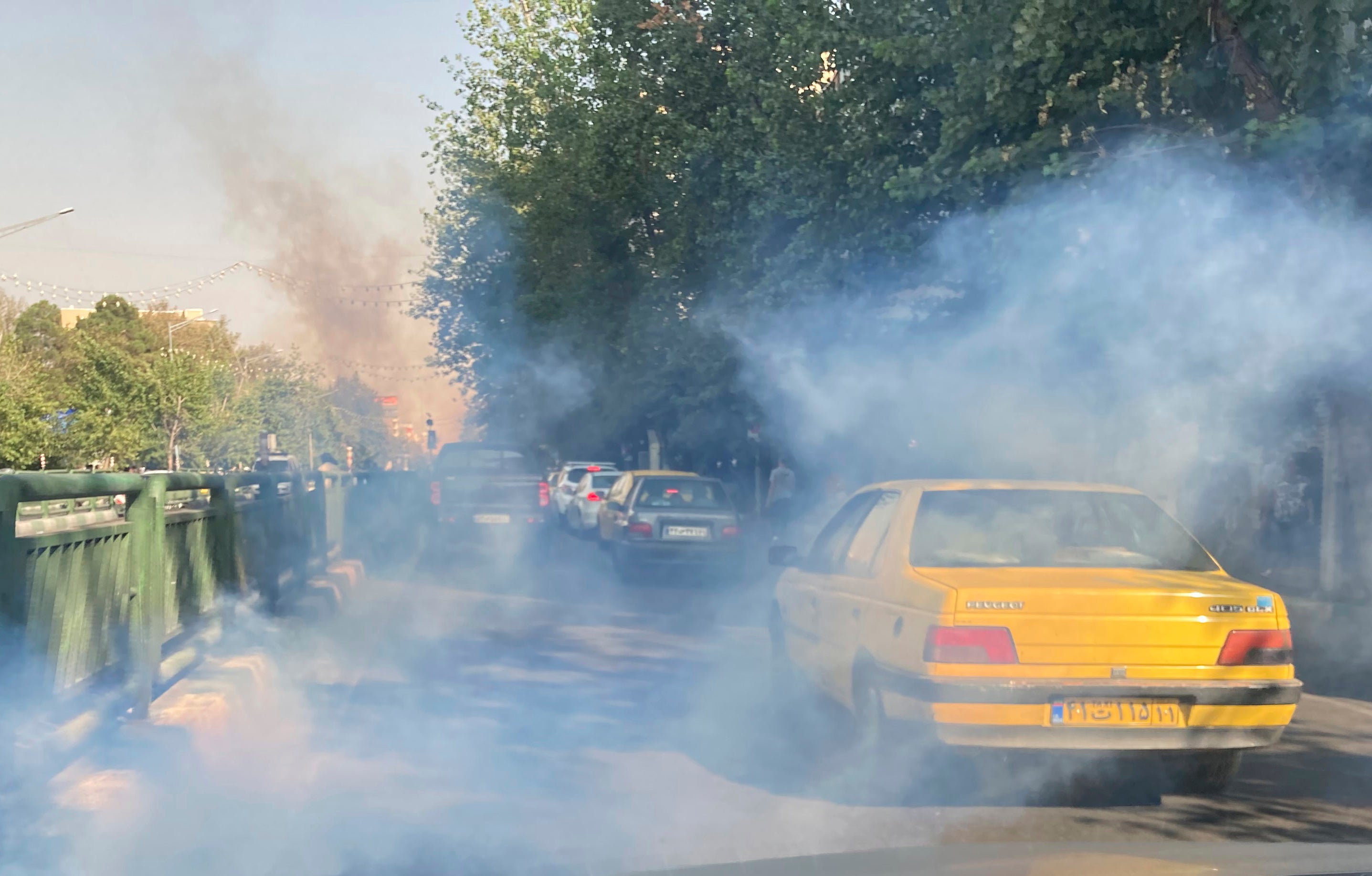 Teargas used to disperse protesters can be seen outside the University in Tehran