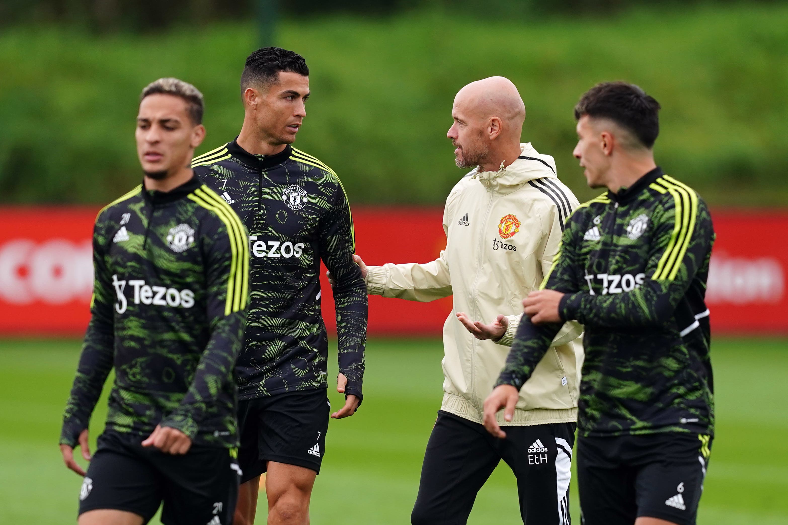 Erik ten Hag, centre right, speaks to Cristiano Ronaldo, centre left, in training (Martin Rickett/PA)
