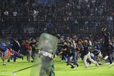 At least 125 people die in football stadium crush in Indonesia following ticket oversell