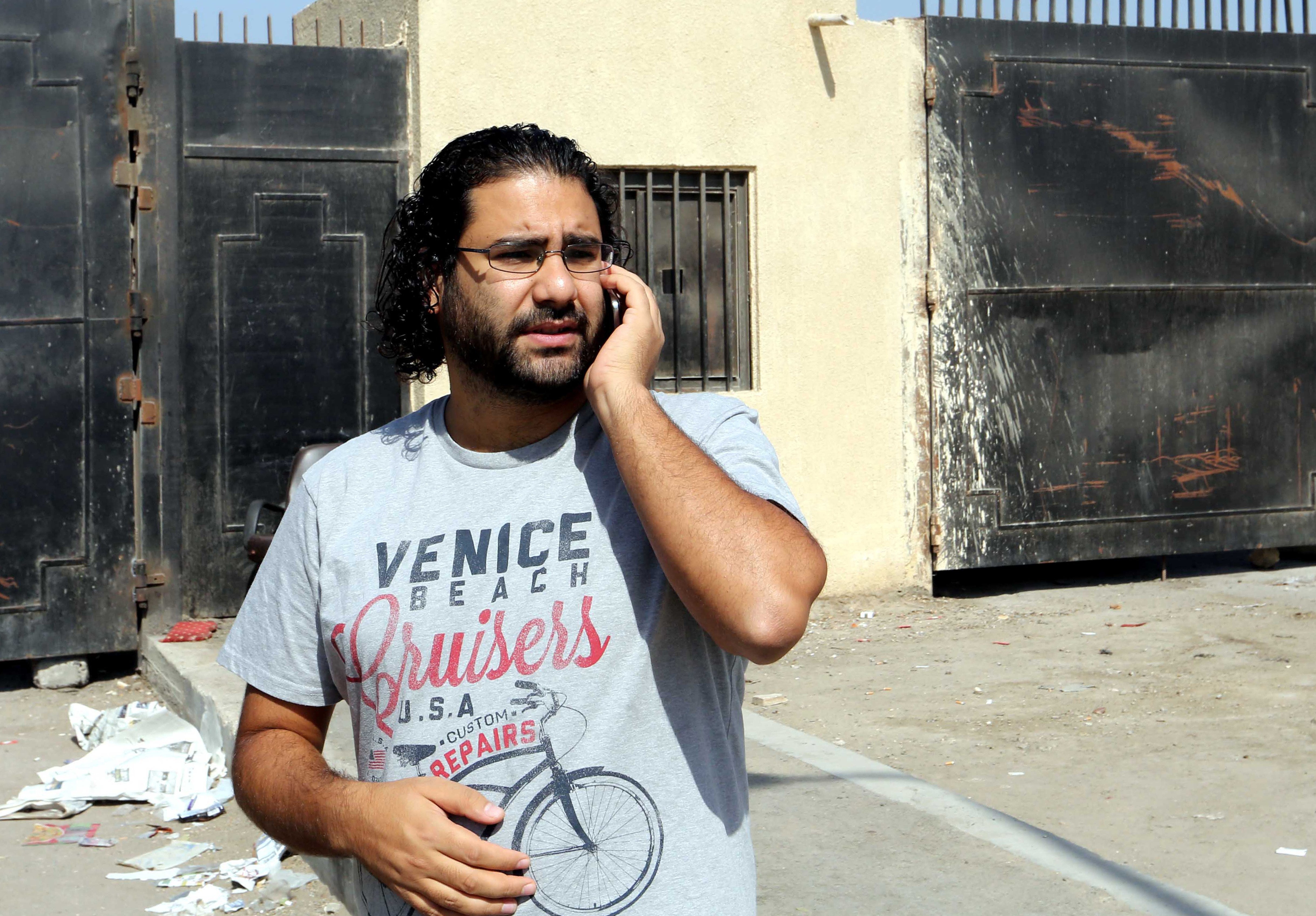 Egyptian activist Alaa Abdel Fattah stands outside the police institute in Cairo's Tora prison in July 2014