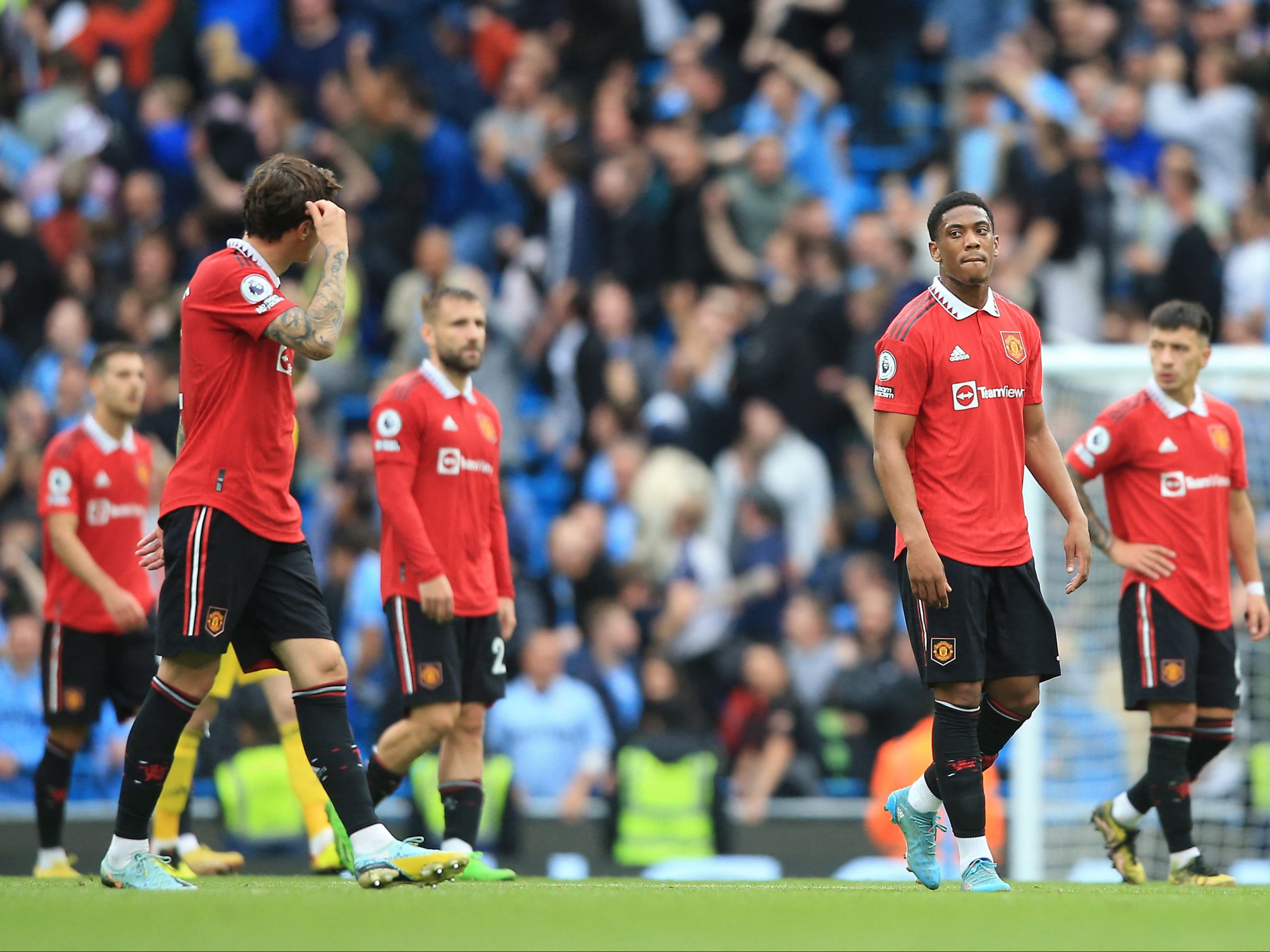 Manchester United players leave the pitch after Sunday’s derby