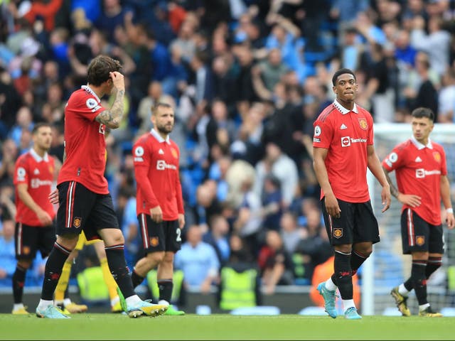 <p>Manchester United players leave the pitch after Sunday’s derby</p>