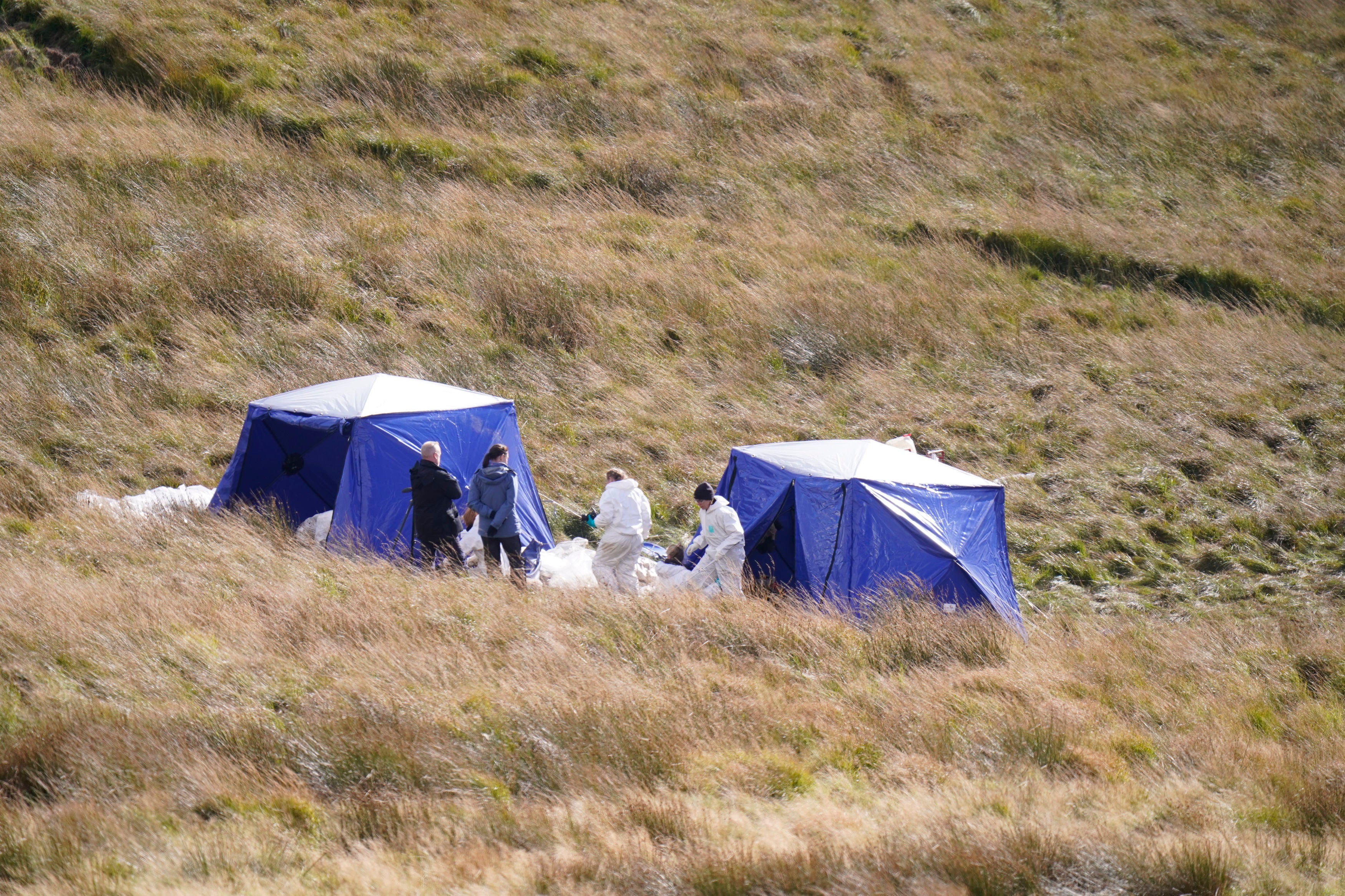 Officers from Greater Manchester Police continue a search on Saddleworth Moor, in north west England
