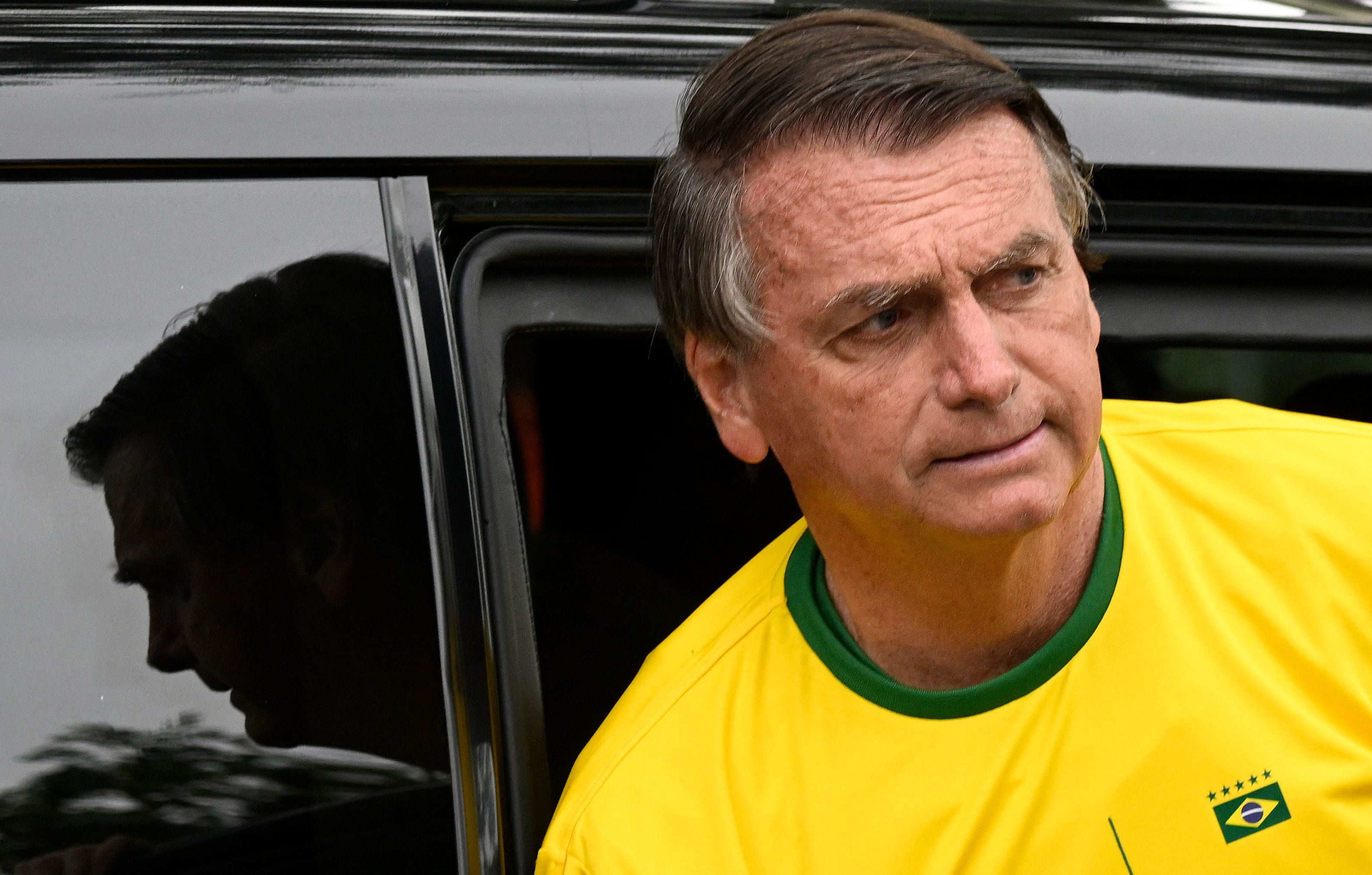 Bolsonaro arrives at a polling station during the contest that he hopes to see him re-elected