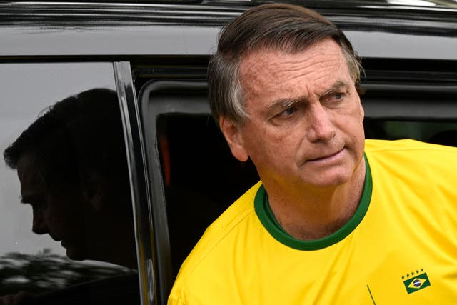 <p>Jair Bolsonaro arrives at a polling station on Sunday </p>