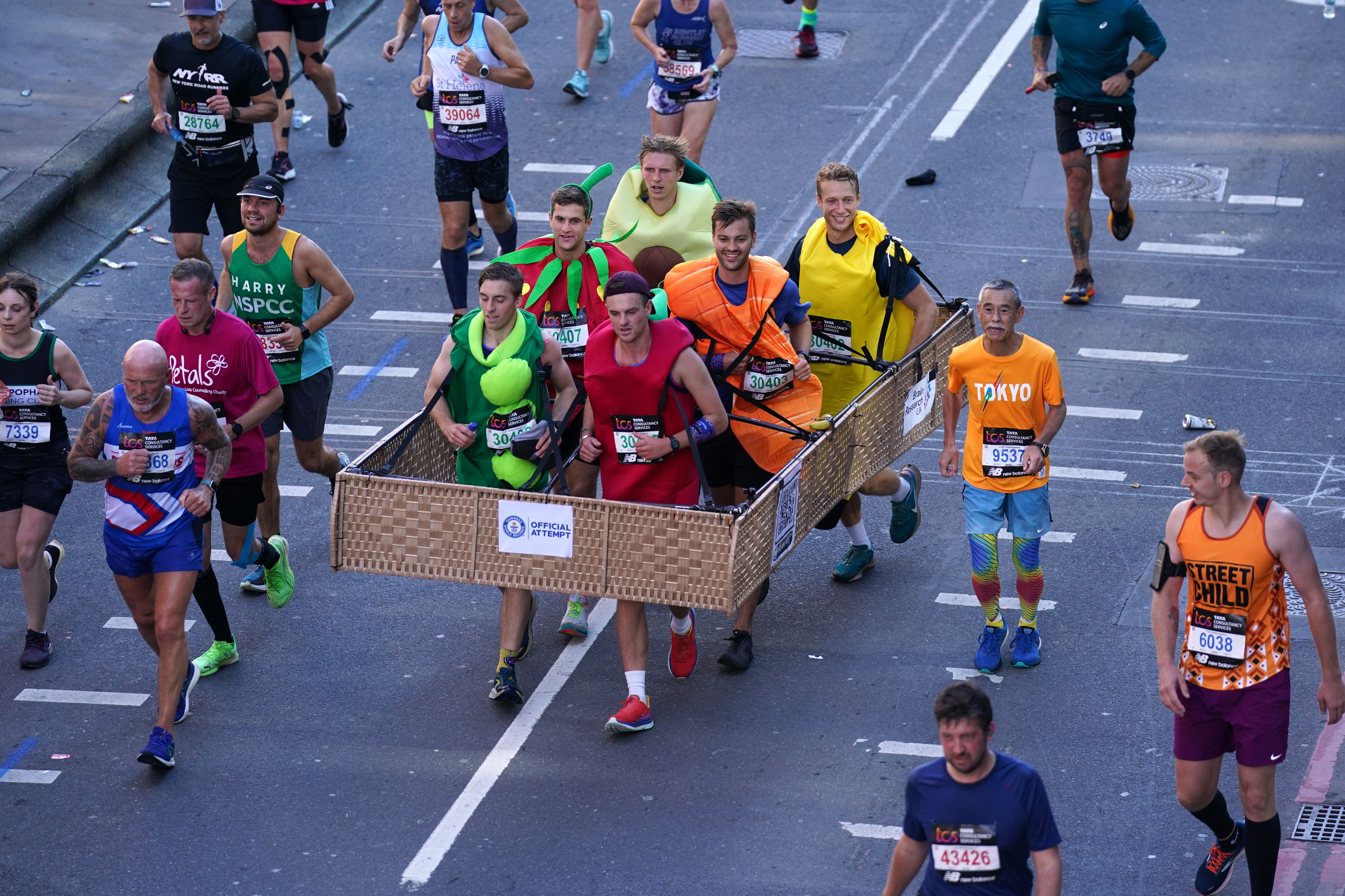 A group of six people dressed as a crate of fruit and vegetables broke the Guinness World Record for the fastest marathon in a six-person costume (Kirsty O’Connor/PA)