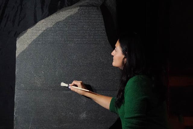 Senior conservator Stephanie Vasiliou prepares the Rosetta Stone (Jonathan Brady/PA)