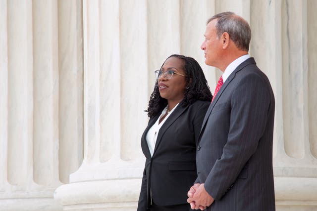<p>US Supreme Court Justice Ketanji Brown Jackson walks the steps of the court with Chief Justice John Roberts on 30 September.</p>