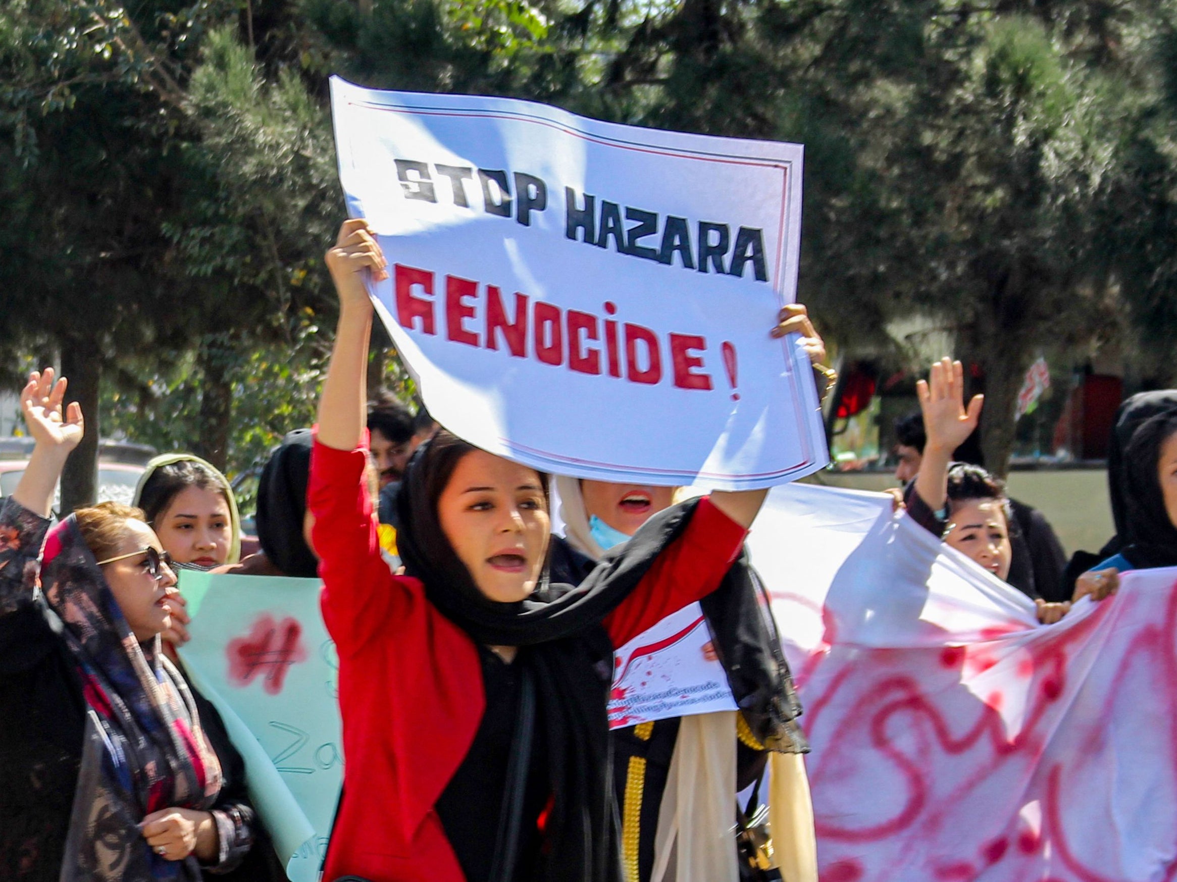 Afghan women display placards and chant slogans during a protest they call Stop Hazara genocide a day after a suicide bomb attack at Dasht-e-Barchi learning centre, in Kabul on October 1, 2022