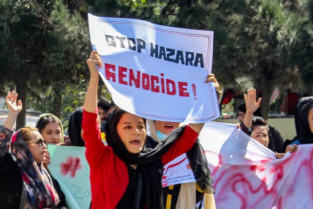 <p>Afghan women display placards and chant slogans during a protest they call Stop Hazara genocide a day after a suicide bomb attack at Dasht-e-Barchi learning centre, in Kabul on October 1, 2022</p>
