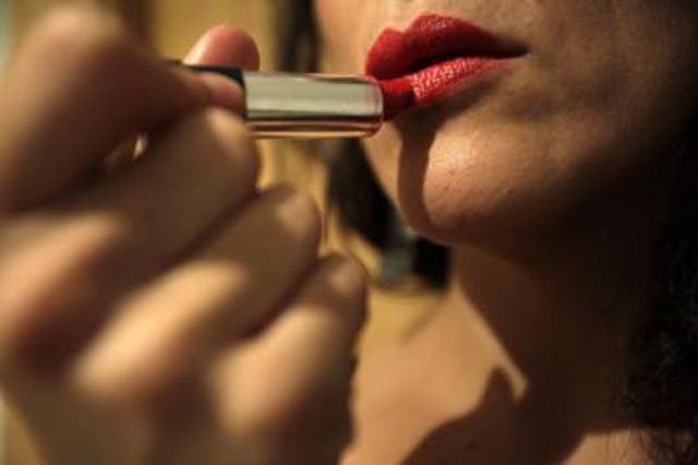 <p>Representational image: Woman using using lipstick</p>