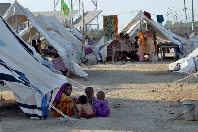 <p>Children play outside their tent at a relief camp in Jaffarabad</p>