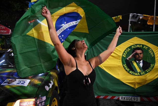 <p>A supporter of Brazilian President Jair Bolsonaro reacts as she watches the vote count </p>