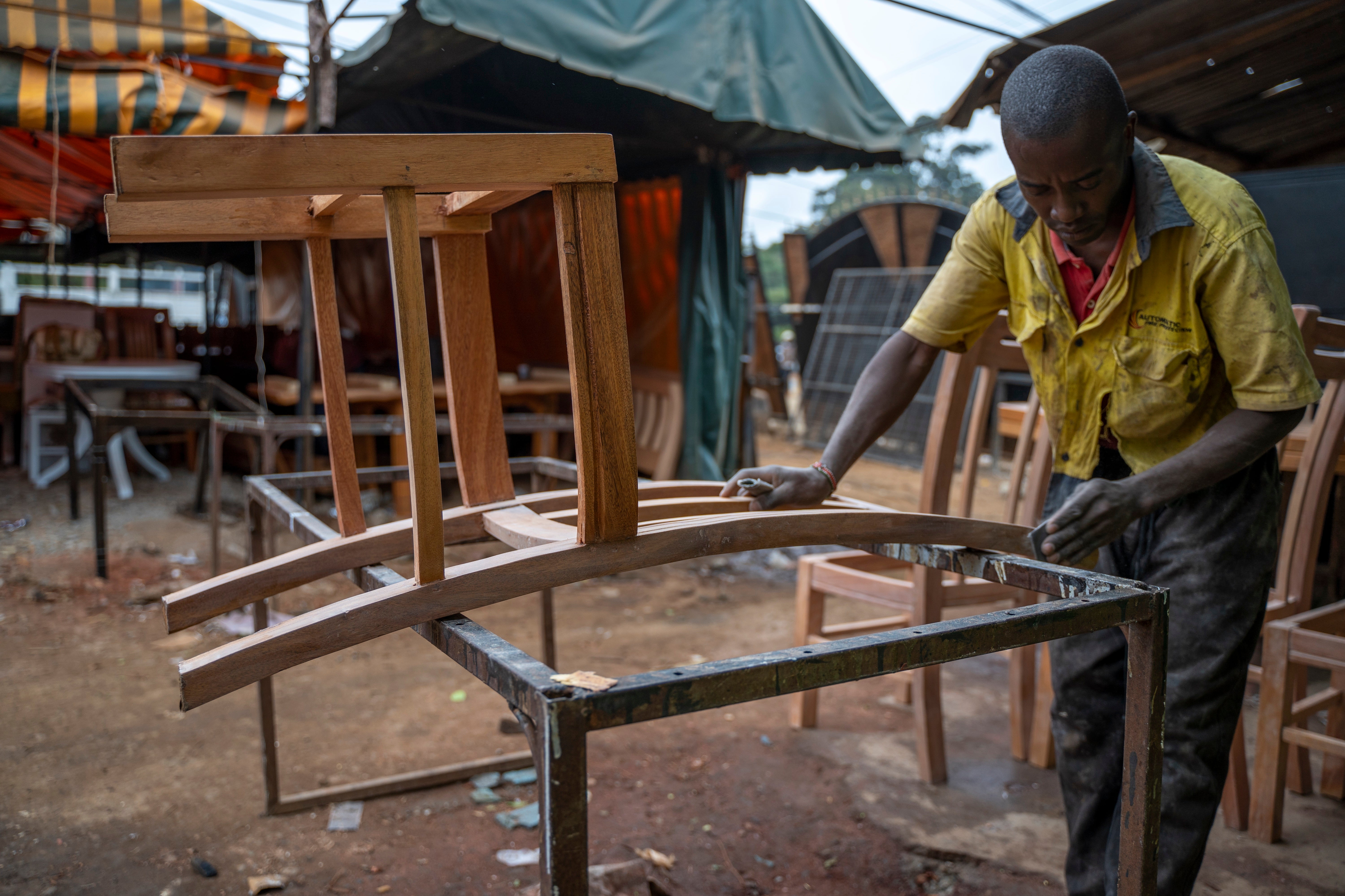 A craftsman on Ngong Road working on a new chair