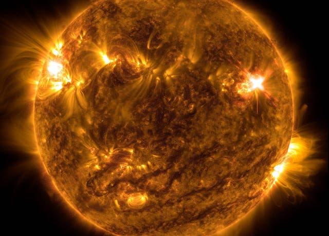 <p>NASA’s Solar Dynamics Observatory captured this image of a solar flare – as seen in the bright flash on the top right – on Oct. 2, 2022. The image shows a subset of extreme ultraviolet light that highlights the extremely hot material in flares and which is colorized in orange</p>