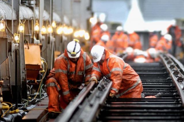 <p>Train strain: Network Rail engineers carry out maintenance on a bridge</p>
