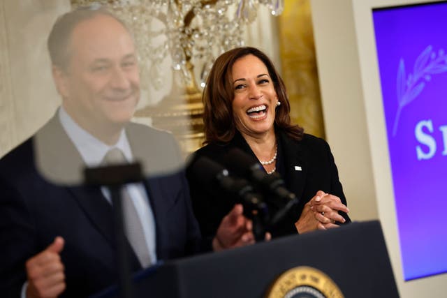 <p>Vice President Kamala  Harris laughs while listening to her husband, second gentleman Doug Emhoff, speak at a White House event</p>