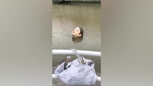 Statue of drowning girl appears in Bilbao river to highlight sustainability issue