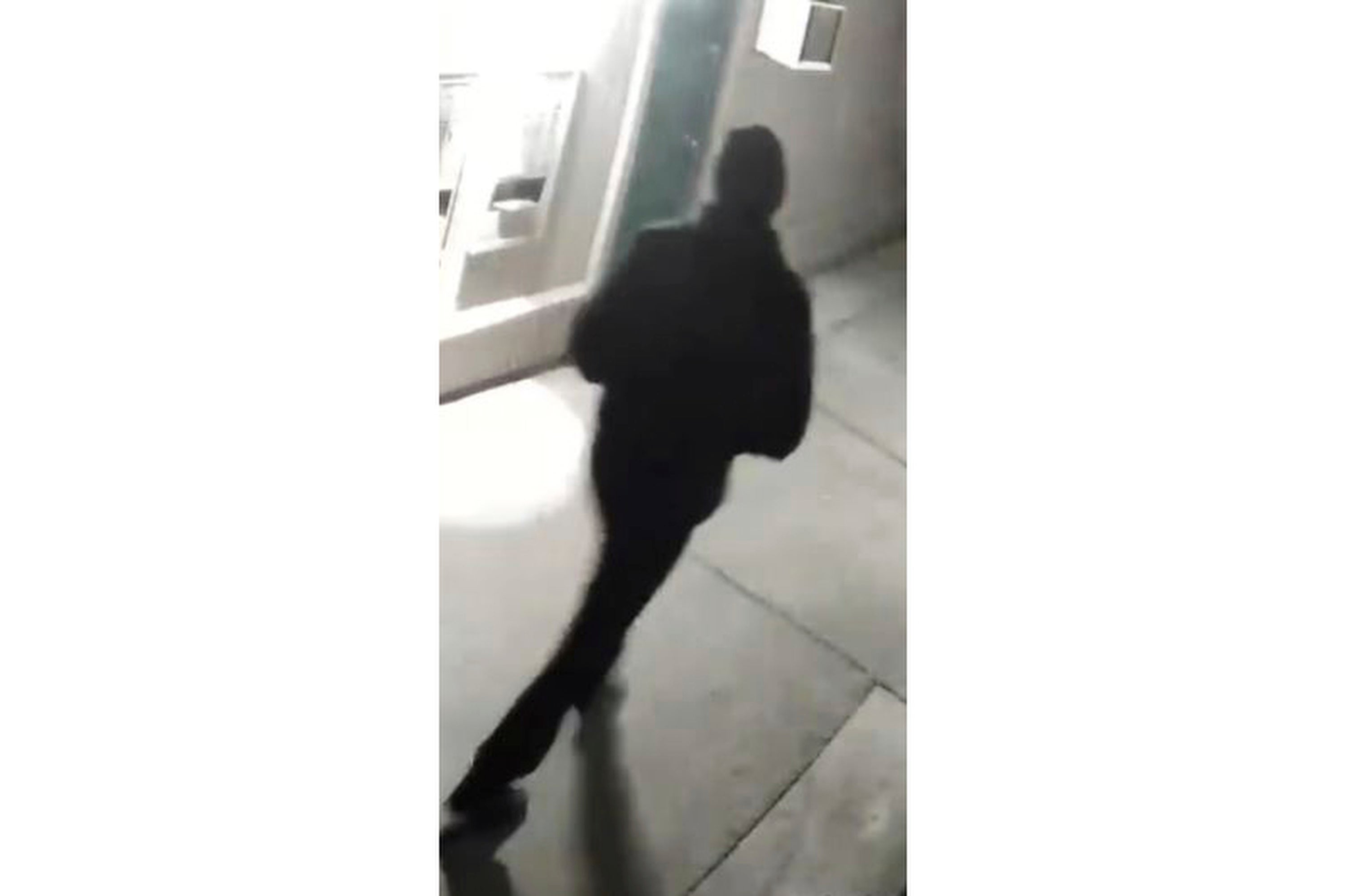 A dark-clad figure was caught on camera near the scenes of several of the shootings