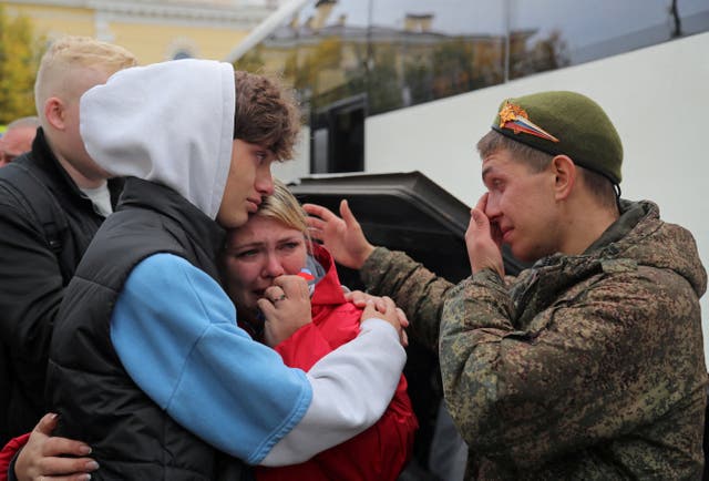 <p>A Russian reservist bids farewell to relatives before his departure for a base in the course of partial mobilisation of troops</p>