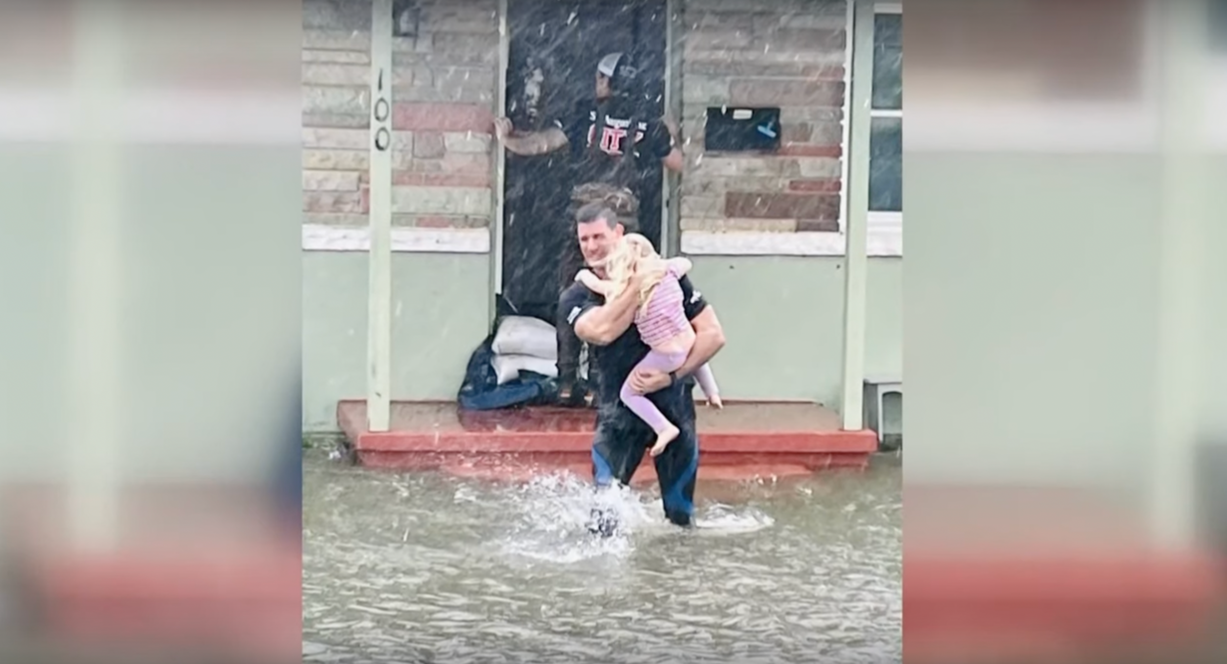 <p>A firefighter rescues a girl from floods in St Augustine, Florida last week </p>