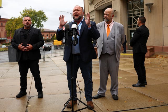 <p>Alex Jones fumes at a press conference outside the Sandy Hook trial on 4 October </p>