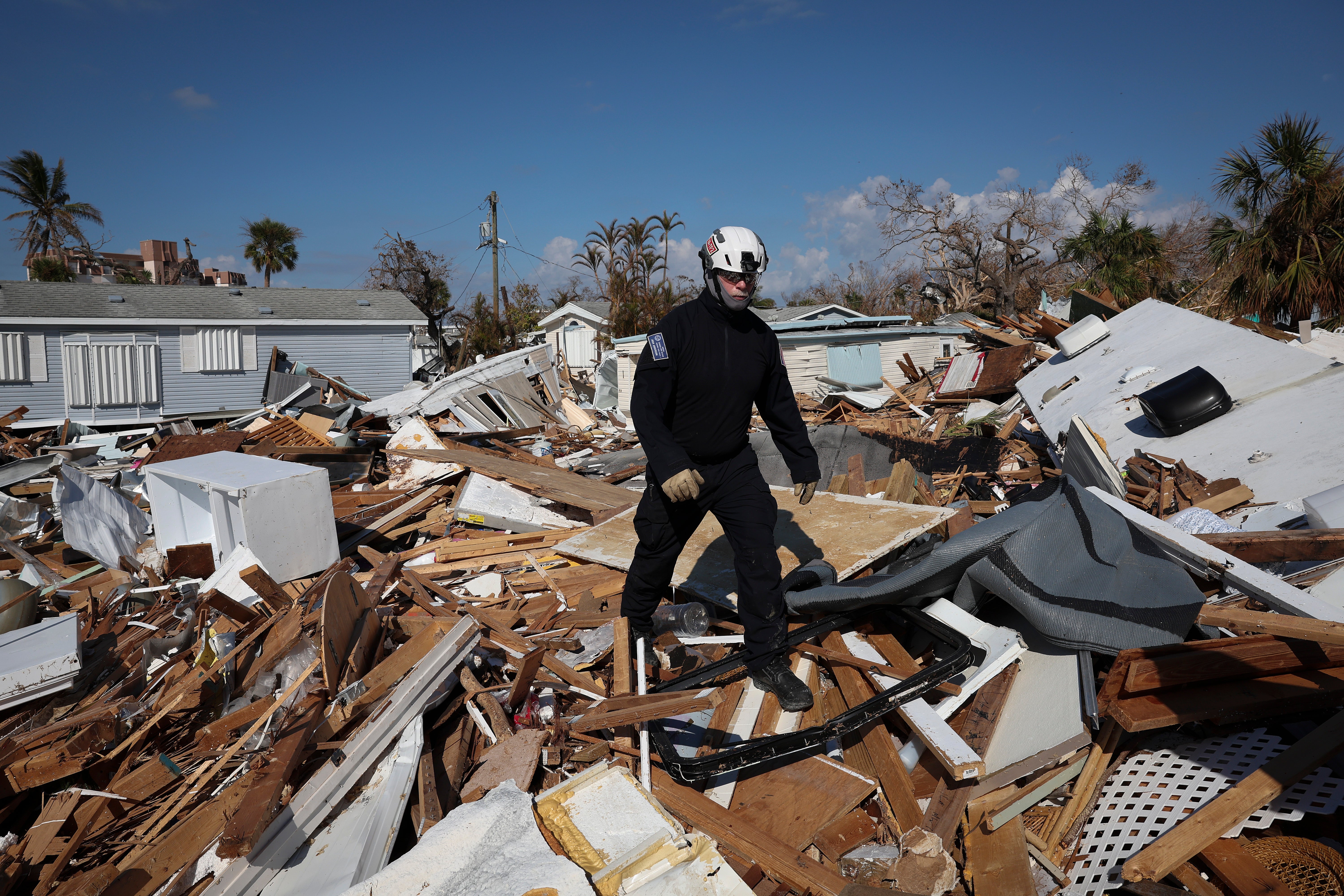 A rescue worker searches for Hurricane Ian victims in Fort Myers Beach on Tuesday