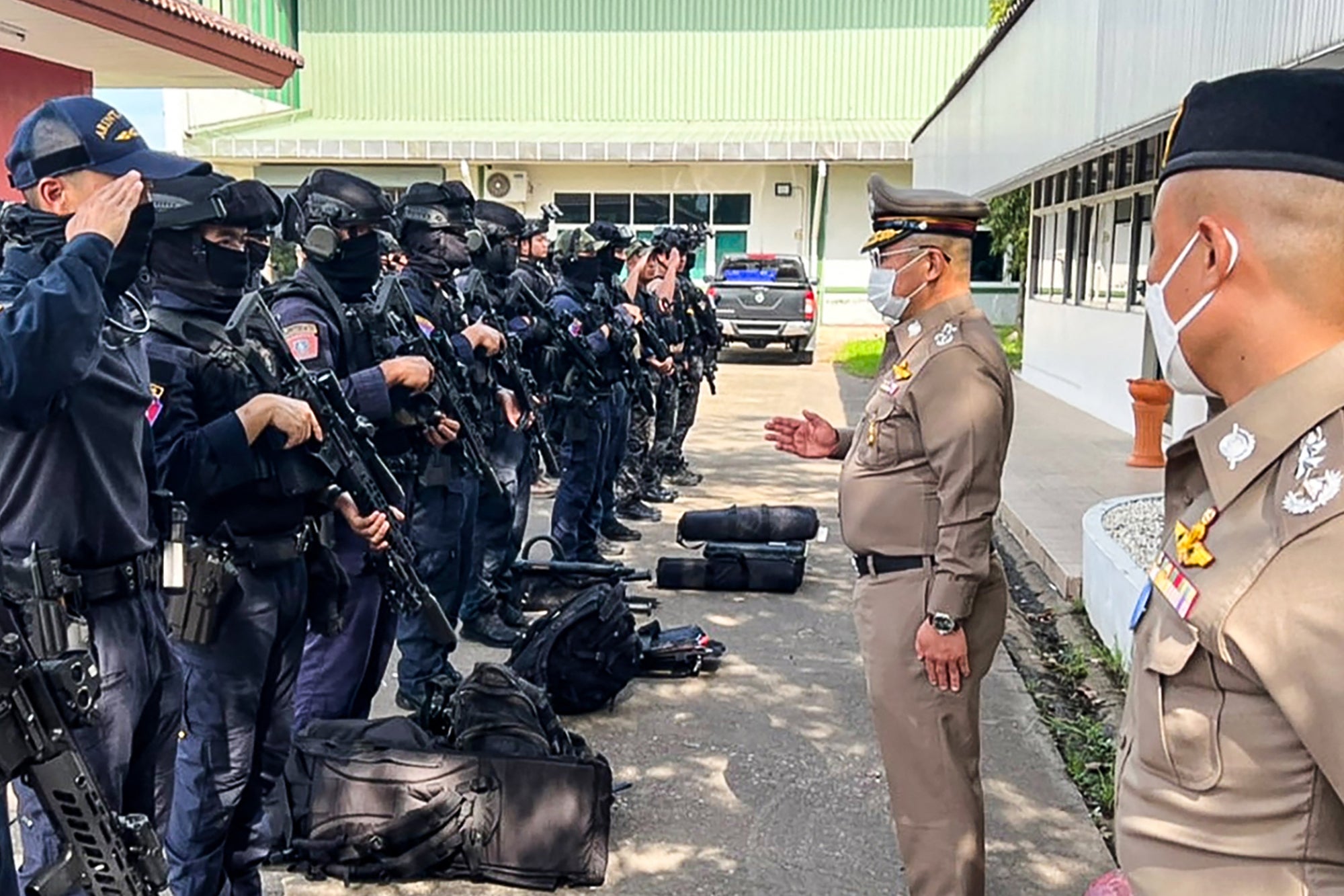 Police chief Damrongsak Kittiprapat speaks with a police operation team