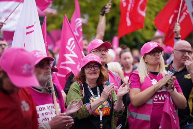 Members of the Communication Workers Union (CWU) demonstrate during a strike outside Belfast Town Hall (Niall Carson/PA)