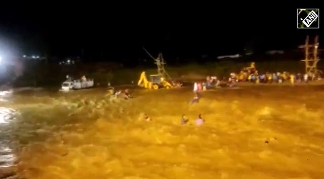 <p>Screengrab from a video showing people being swept away during a flash flood in West Bengal on Wednesday, 5 October 2022</p>