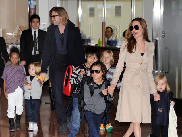 <p>Estranged couple Brad Pitt and Angelina Jolie photographed with their six children in 2011 </p>